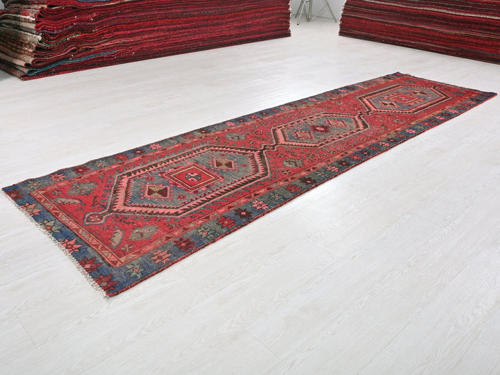 a pile of red rugs sitting on top of a white floor