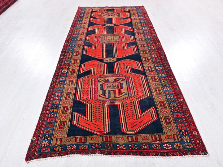 a red and blue rug on a white floor