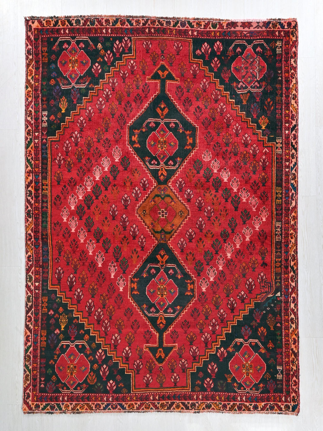 a red and black rug with a diamond pattern