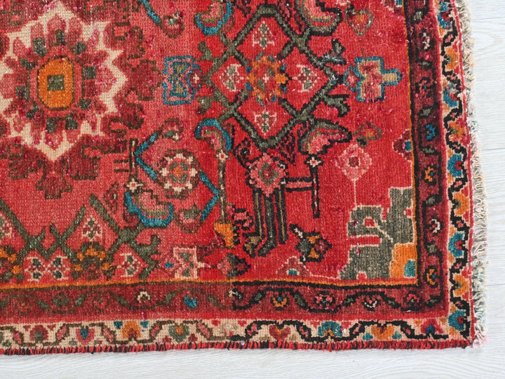 a red rug with a colorful design on it
