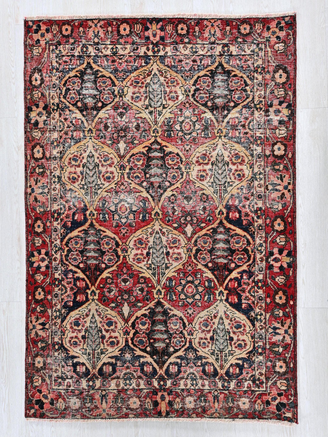 a red and black rug with an intricate design