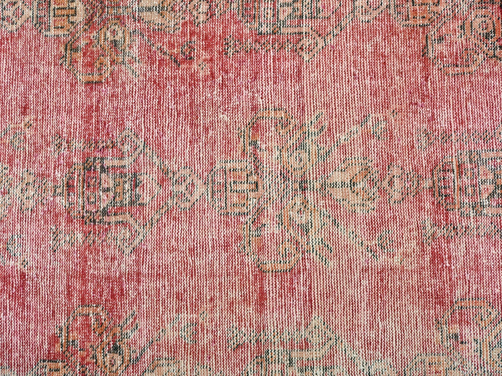 a red rug with a pattern on it