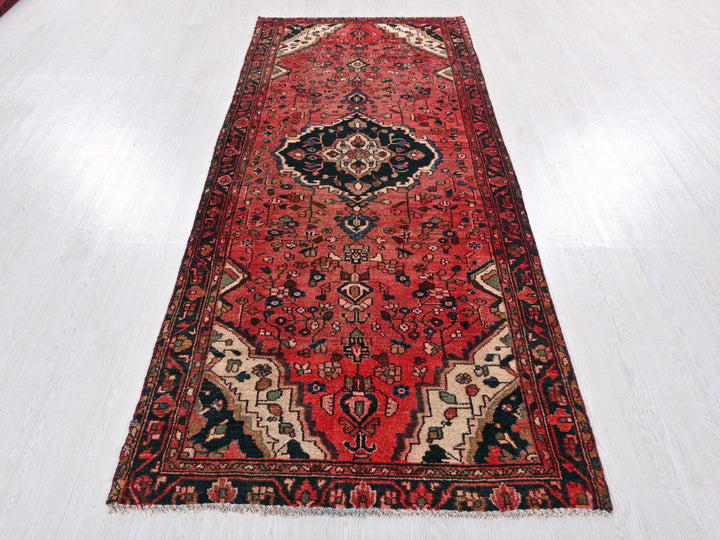 a long red rug on a white floor