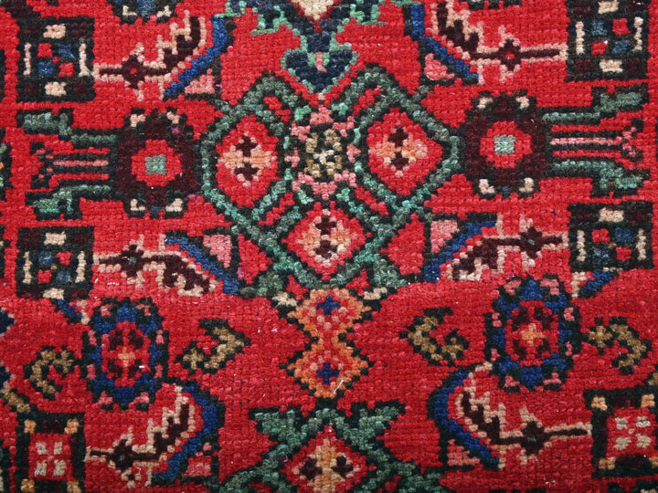 a close up of a red rug with a pattern