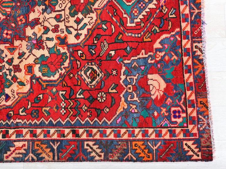 a colorful oriental rug on a wooden floor