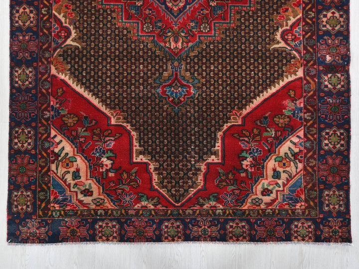 a red and blue rug on a white background
