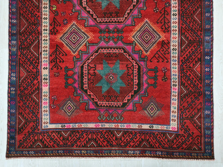 a red rug with a colorful design on it