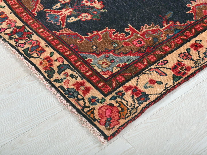 a blue rug with a red border on a white floor