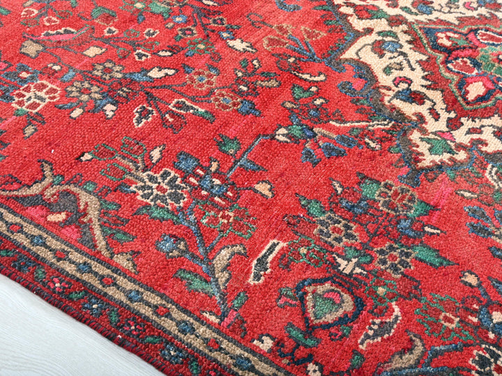 a red rug with a floral design on it