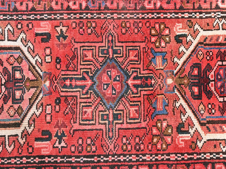 a red rug with a design on it