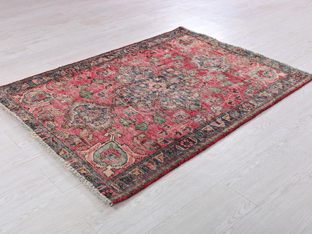 a red and blue rug on a white floor