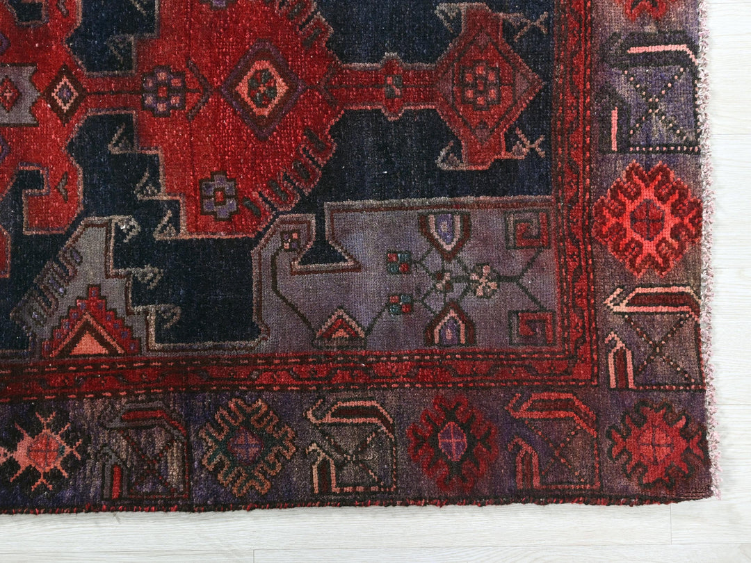 a red and blue rug with a design on it
