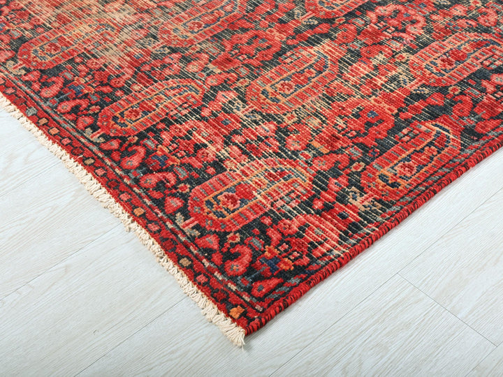 a red and black oriental rug on a white floor