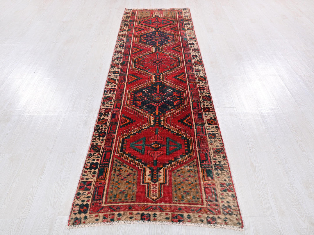 a long red rug on a white floor