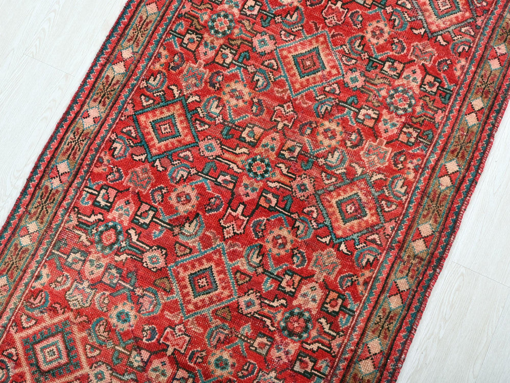 a red rug on a white wooden floor