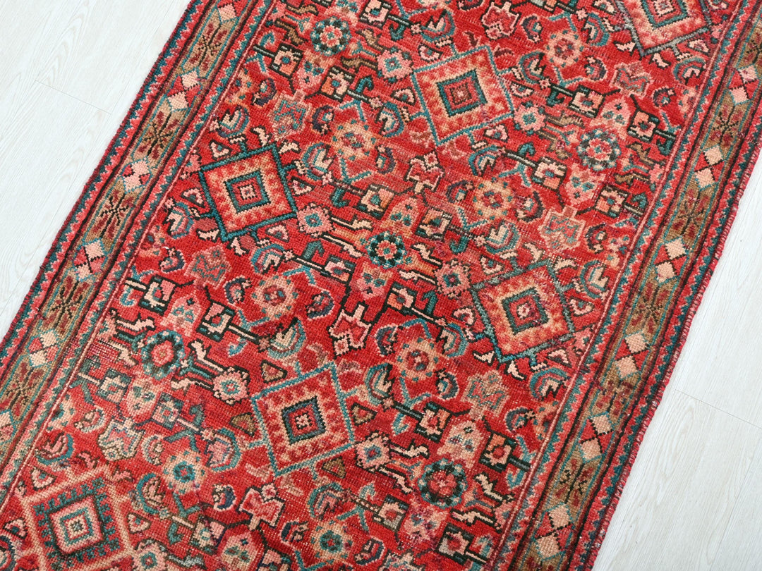 a red rug on a white wooden floor
