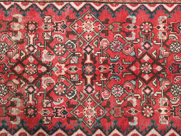 a red rug with a pattern on it