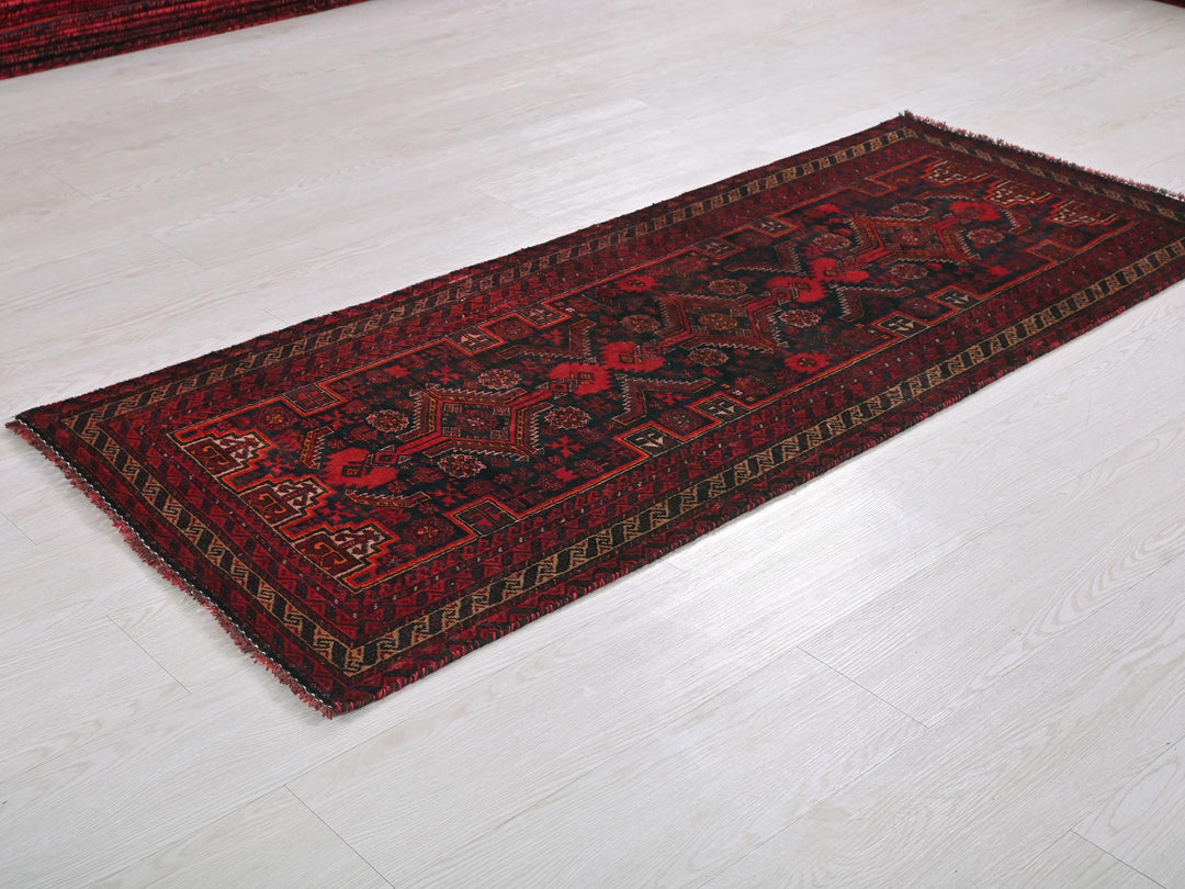 a red rug on a white floor in a room