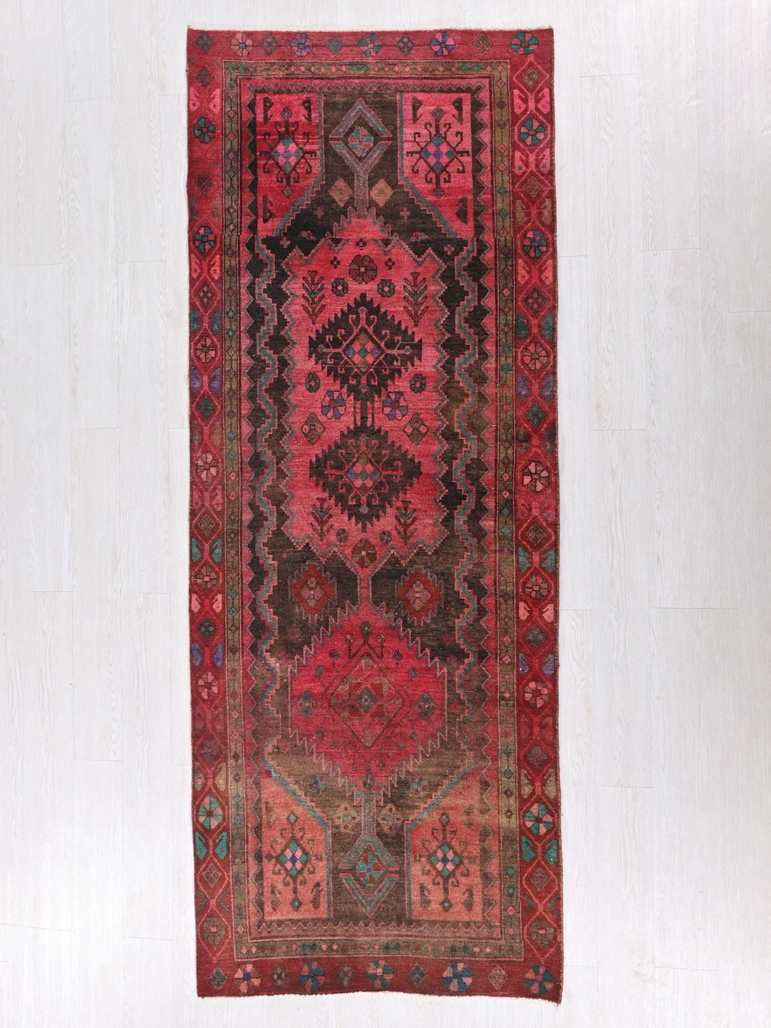 a red rug hanging on a wall