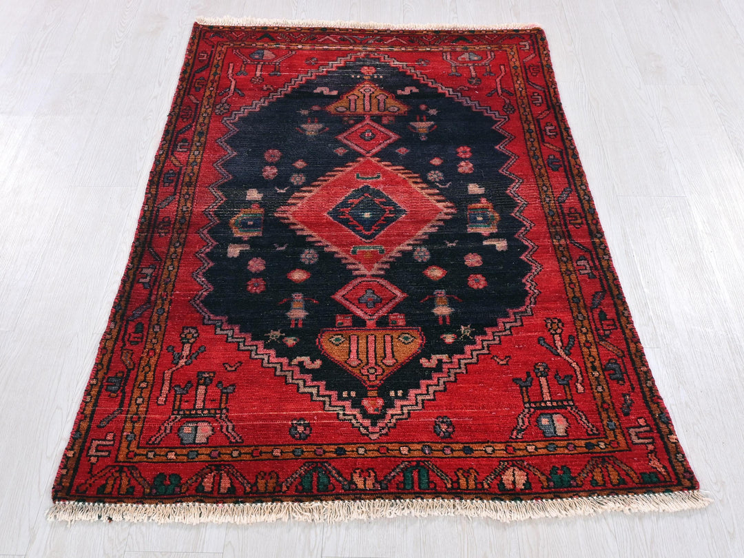 a red and black oriental rug on a white floor