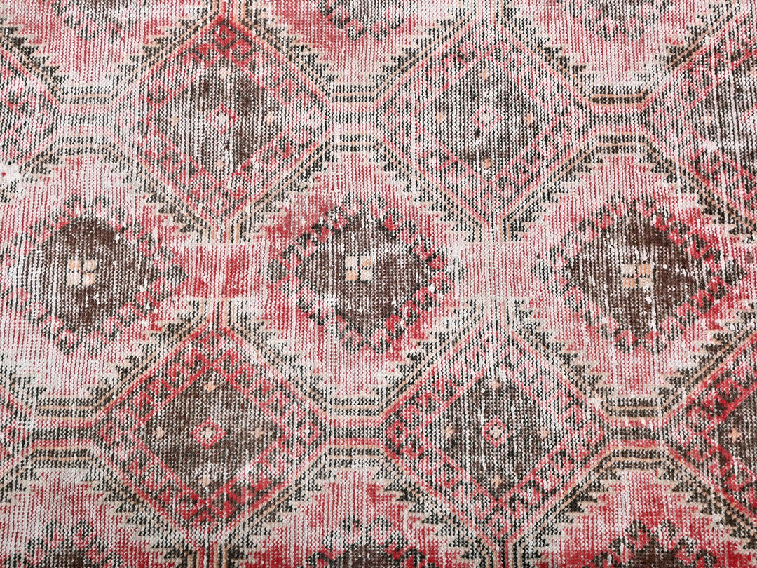 a close up of a red and brown rug