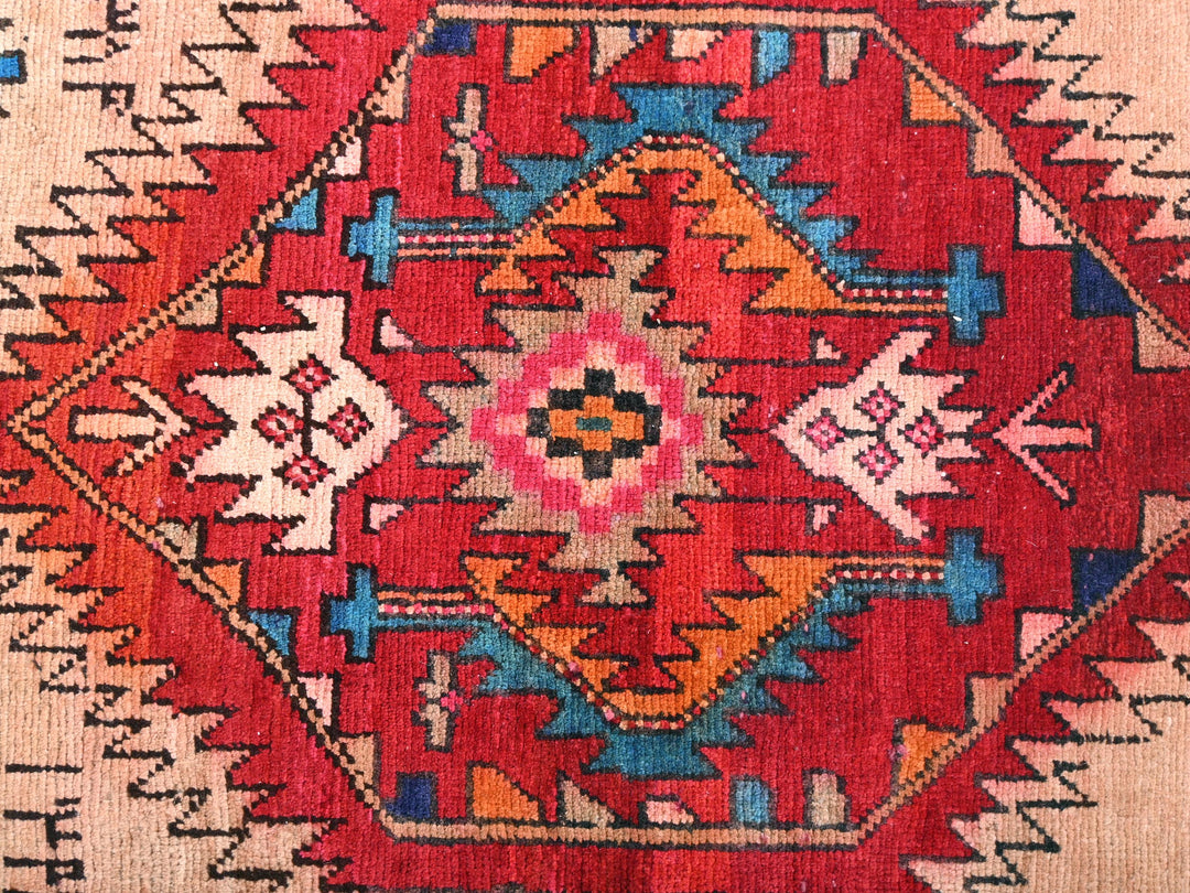 a red rug with a colorful design on it