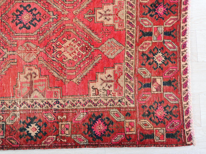 a red rug with many different designs on it