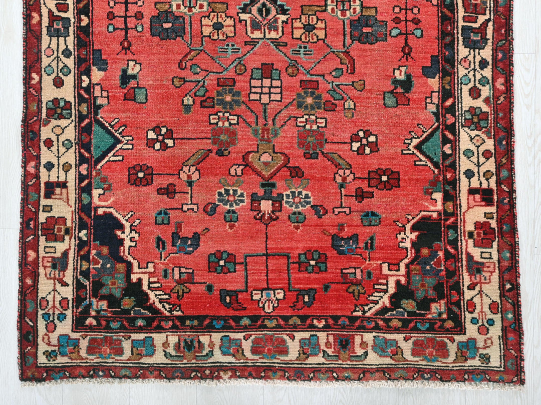 a red rug with a floral design on it