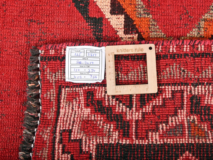 a red rug with a white tag on it