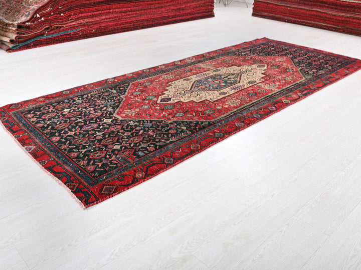 a red rug is laying on a white floor