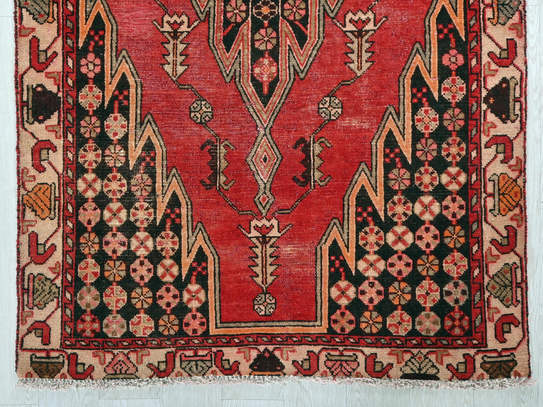 a red and black rug on a white wall