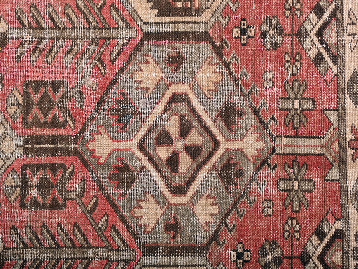 a red rug with a pattern on it