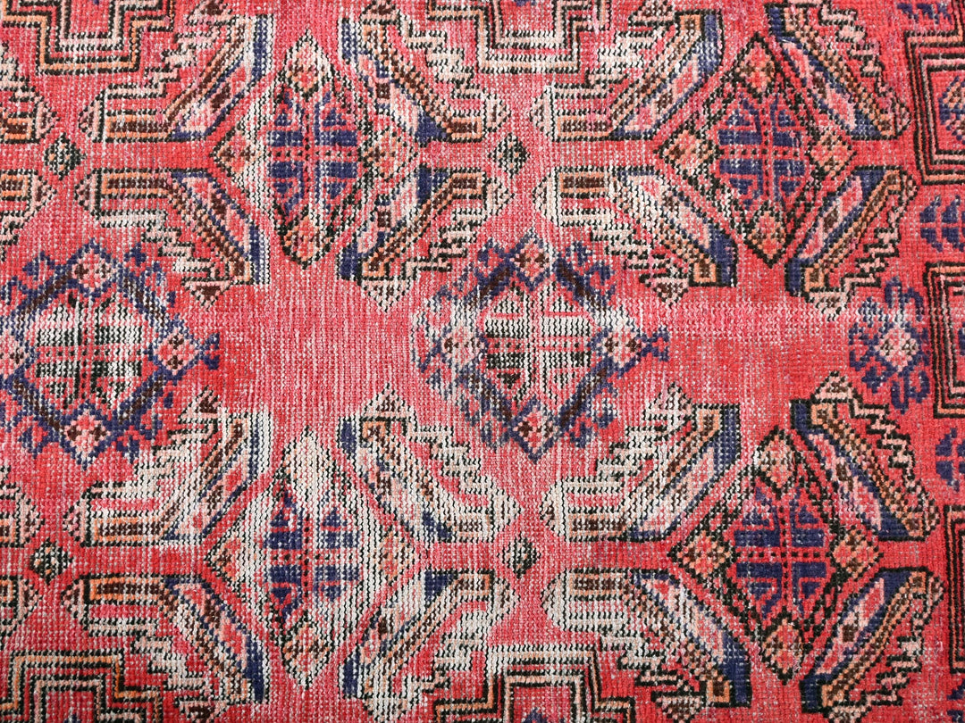a red and blue rug with a pattern on it