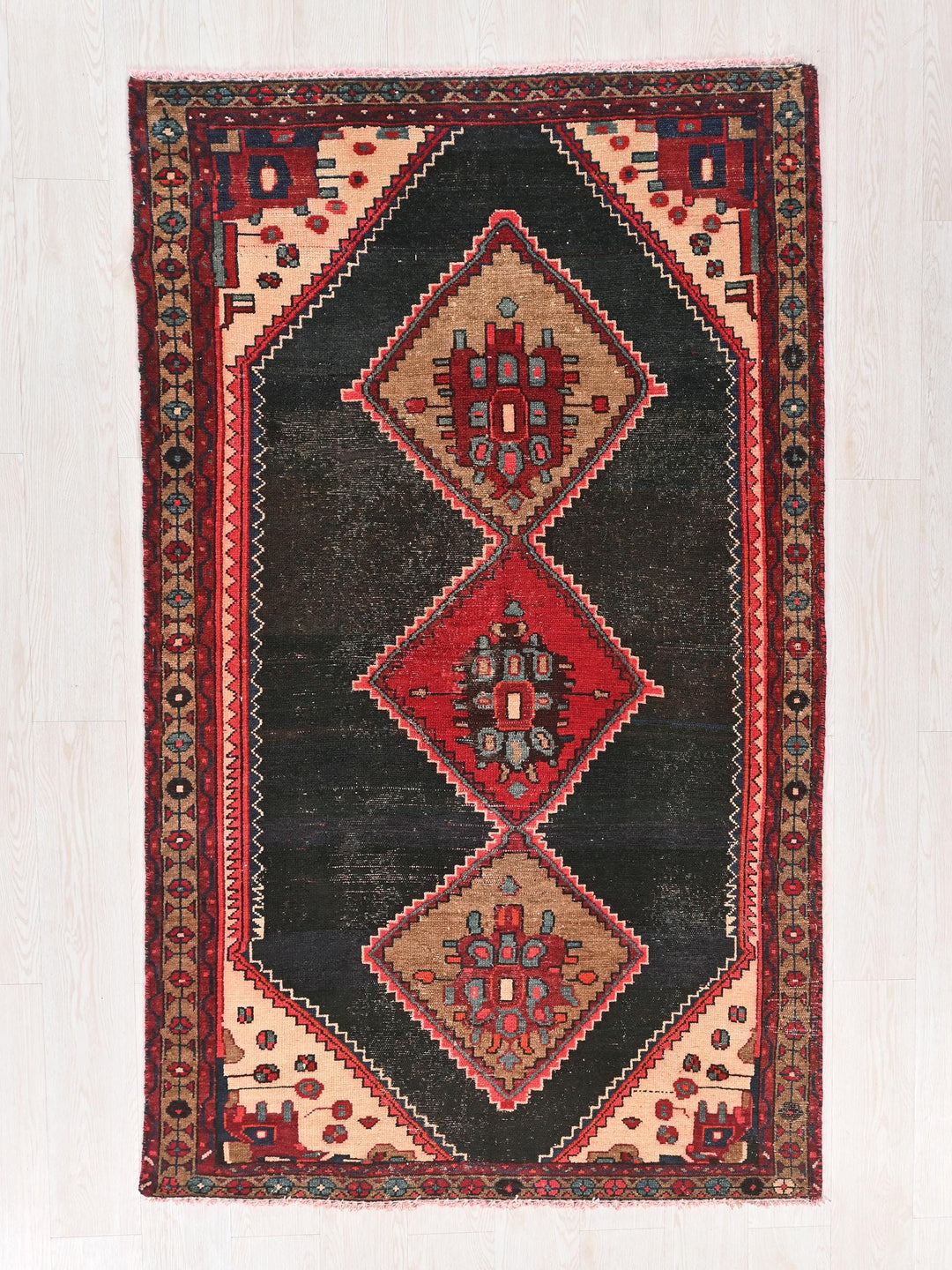 a black and red rug with a diamond design