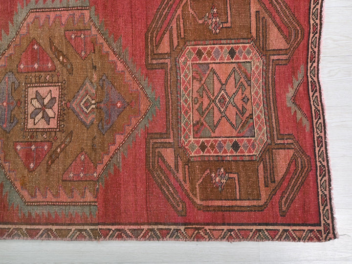a red rug with a design on it