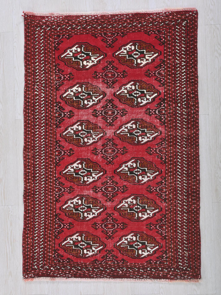 a red rug on a white wooden floor