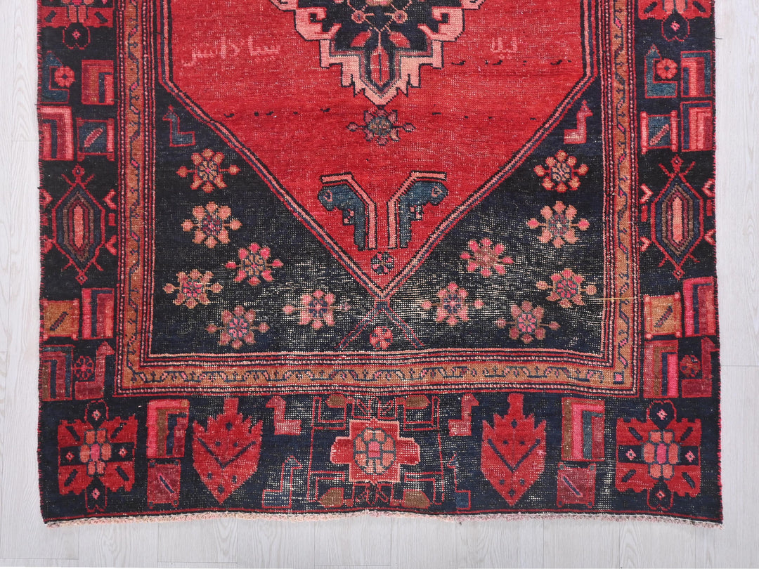 a red rug with a black border and a blue border