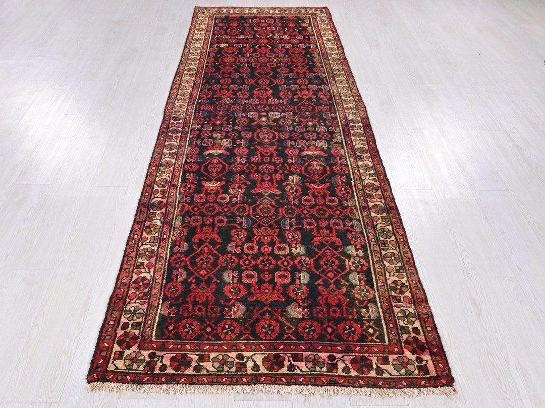 a red and black rug on a white floor