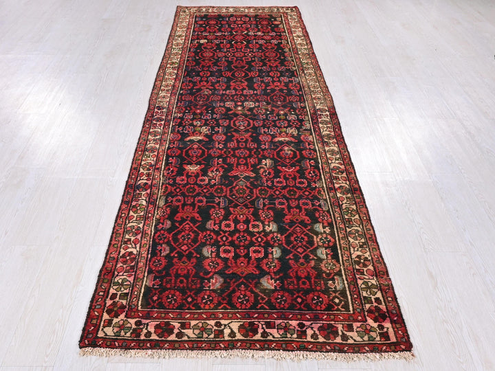 a red and black rug on a white floor