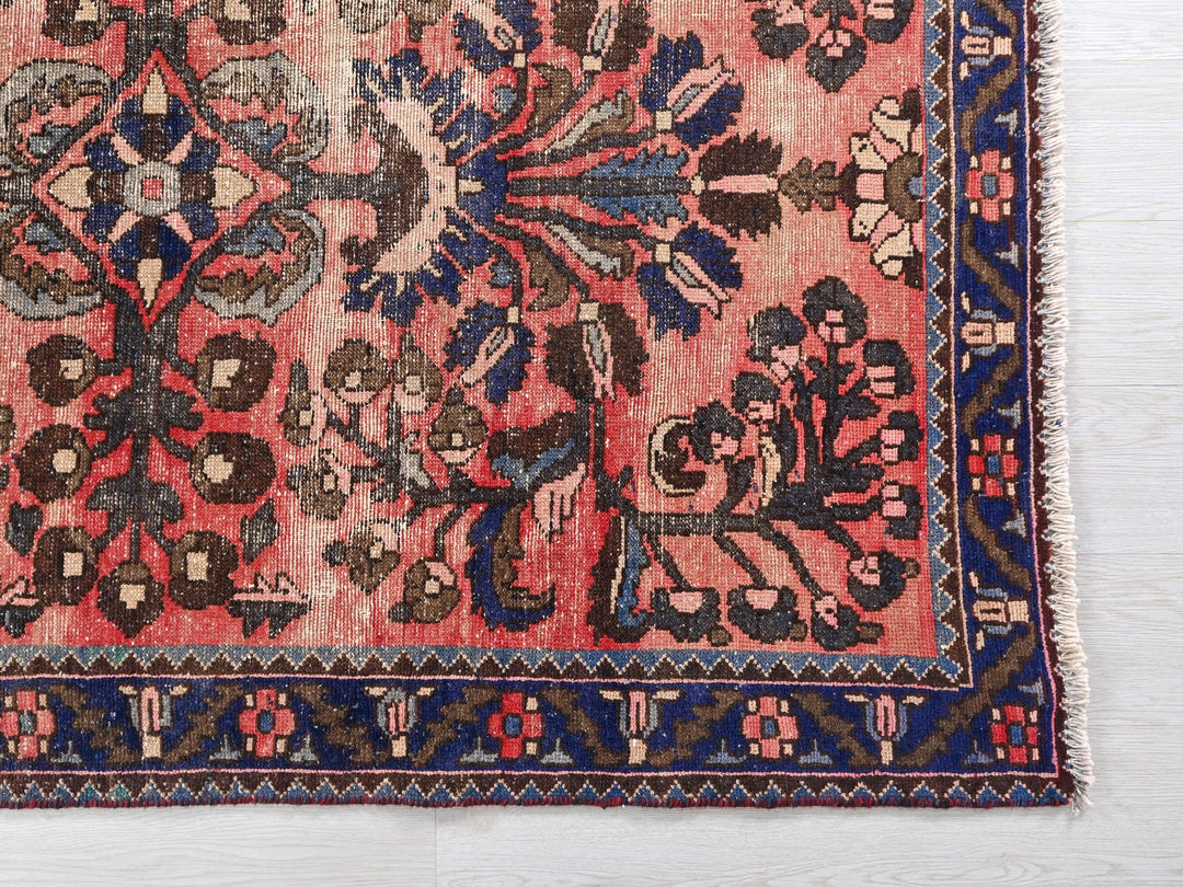 a red rug with blue and brown designs on it