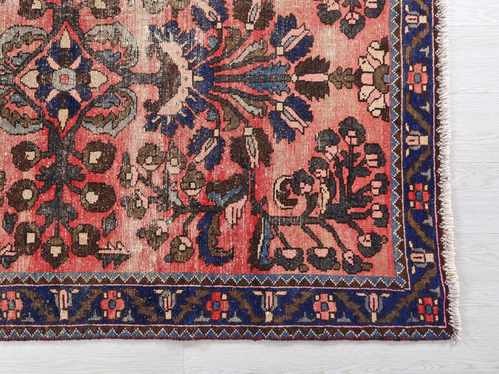 a red rug with blue and brown designs on it