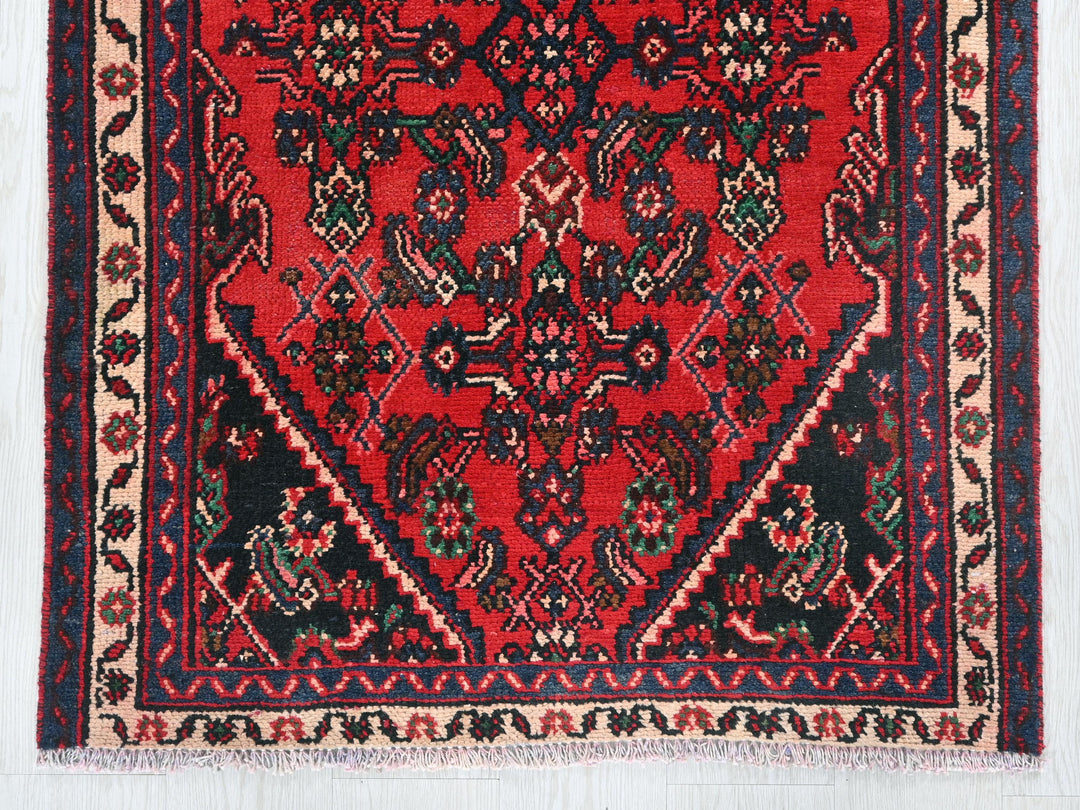 a red rug with a black border on a white background