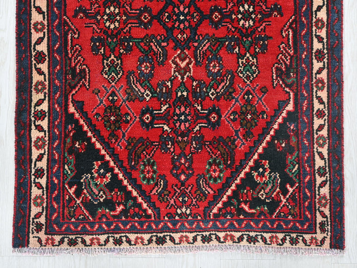 a red rug with a black border on a white background