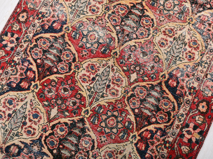 a red and blue oriental rug on a wooden floor