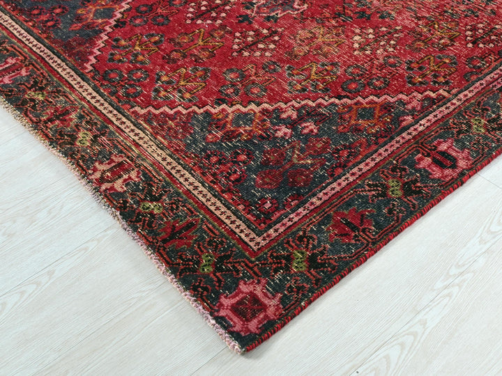 a red and black oriental rug on a white floor