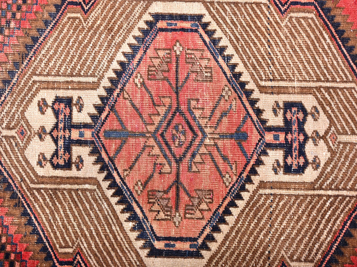 a close up of a rug with a red and blue design