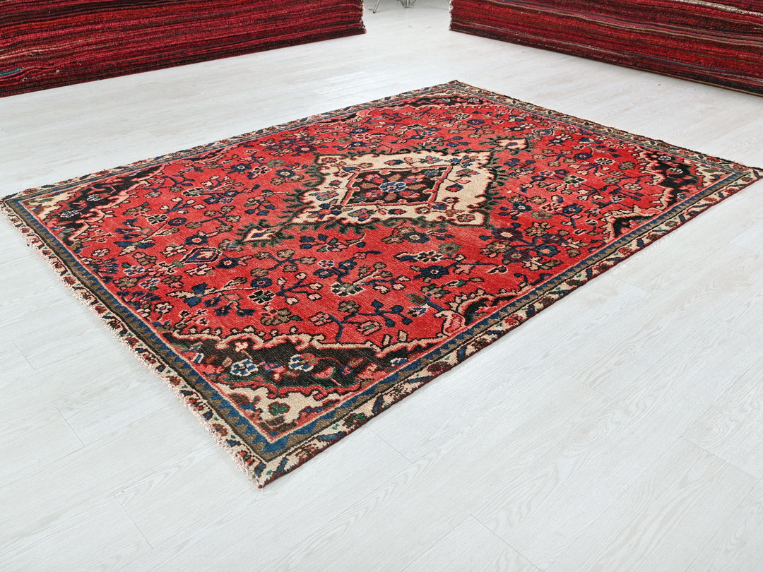 a red oriental rug on a white floor