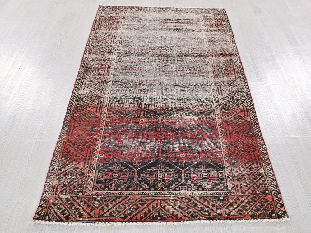 a red and black rug on a white floor