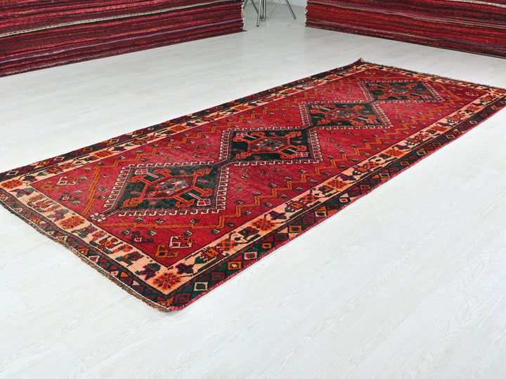 a red rug on the floor of a room
