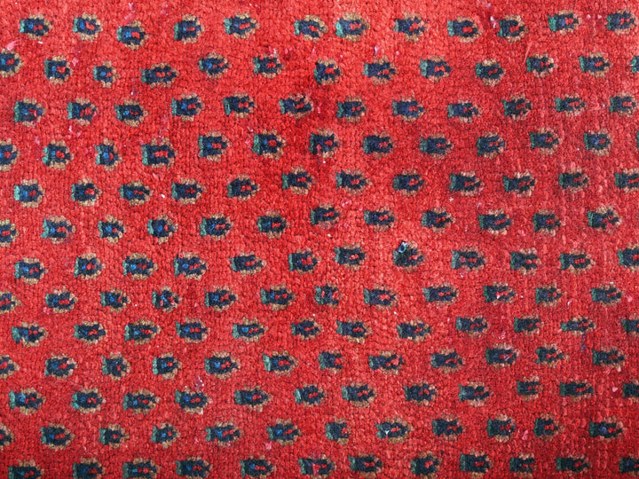 a close up of a red carpet with blue flowers on it